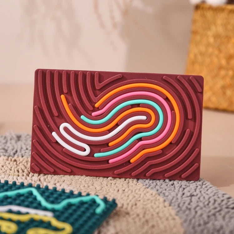 Colorful wavy-patterned object on a textured surface
