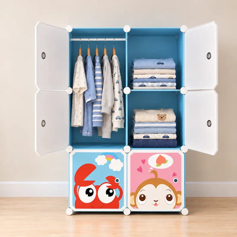 A 5-in-1 plastic modular children's wardrobe with white doors, a blue interior, and colorful cartoon-printed bottom storage bins. The wardrobe is shown open and styled with baby clothes and folded towels against a neutral beige wall and wooden floor.