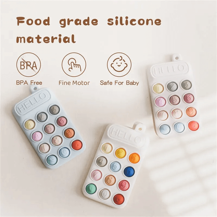 Colorful baby teething toy with 'HELLO' on a light background