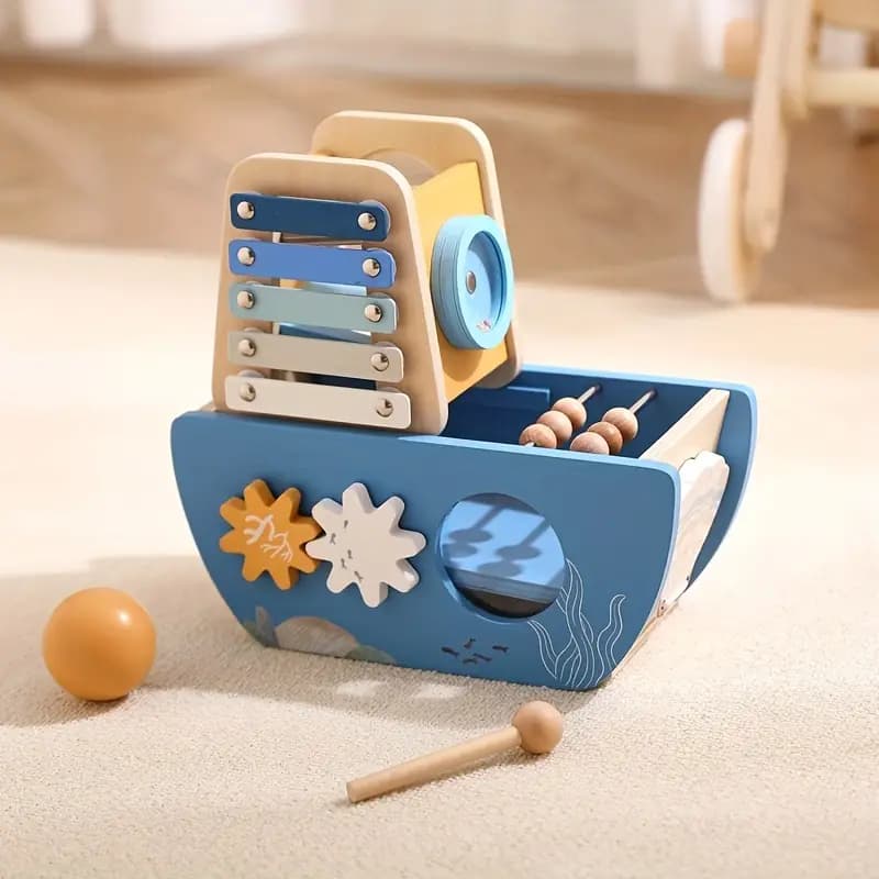 Wooden toy boat with xylophone on a light wooden floor