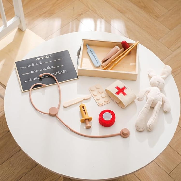 Set of children's medical play toys on a white round table.