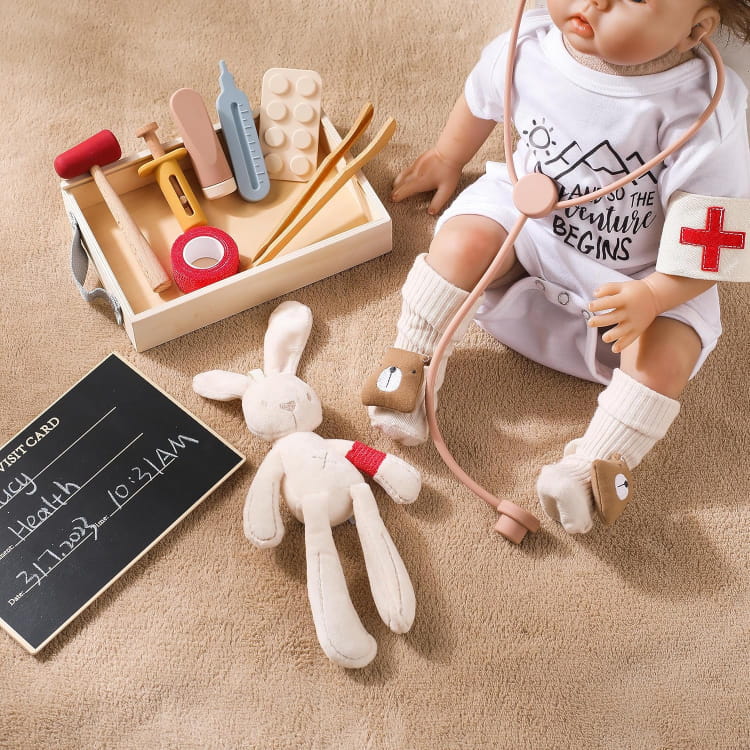Child's play set with toy doctor outfit, tools, and plush rabbit on a beige carpet.
