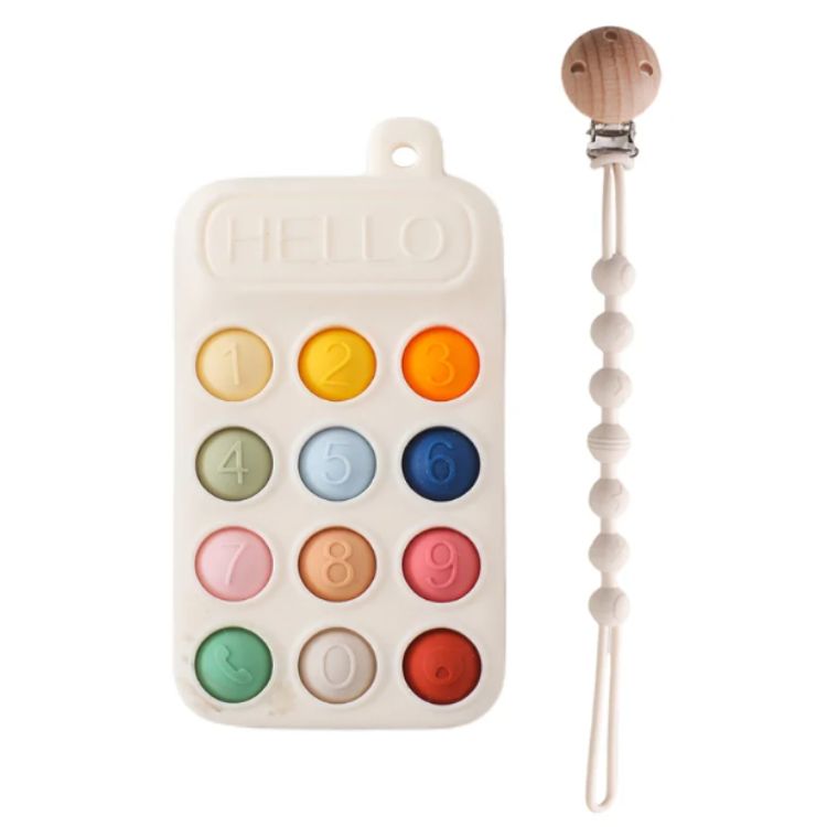 Colorful number block with a wooden teething ring on a white background