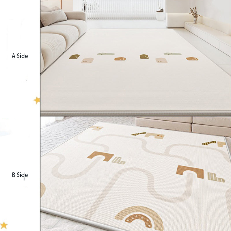 Children's play mat with geometric designs on a white surface.