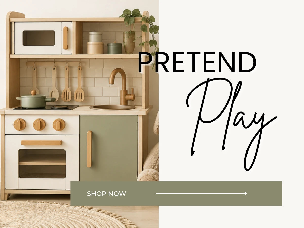 A children's play kitchen set with a light wood frame, cream cabinets, a sage green lower cabinet, and natural wood handles and knobs. The kitchen is styled with small toy appliances, utensils, and a faucet, set against a neutral background with a 'PRETEND Play SHOP NOW' graphic overlay.