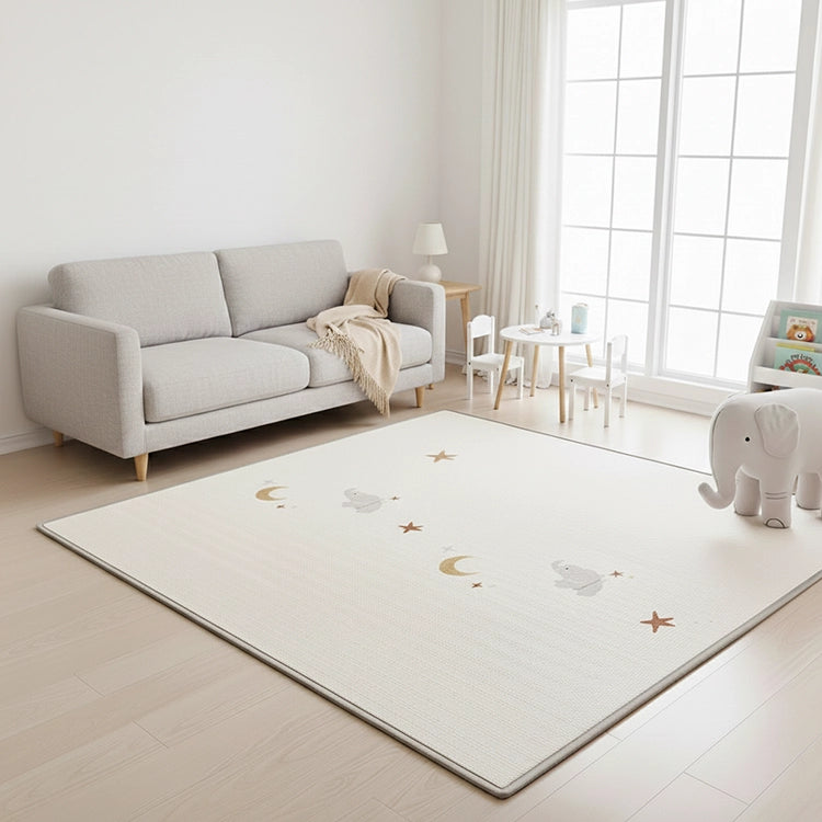 Living room with a gray sofa, rug with star patterns, and children's toys.