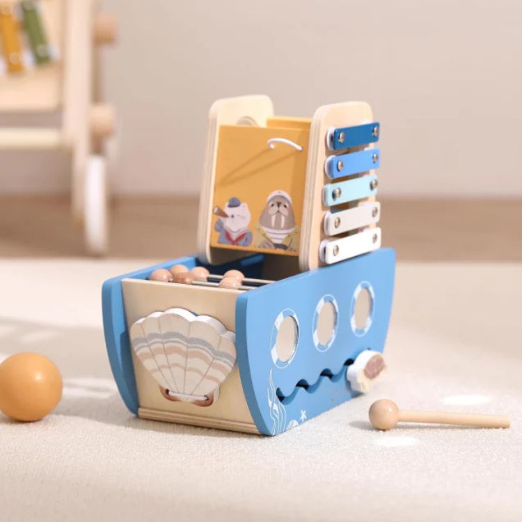 Wooden educational toy with cards and beads on a light surface