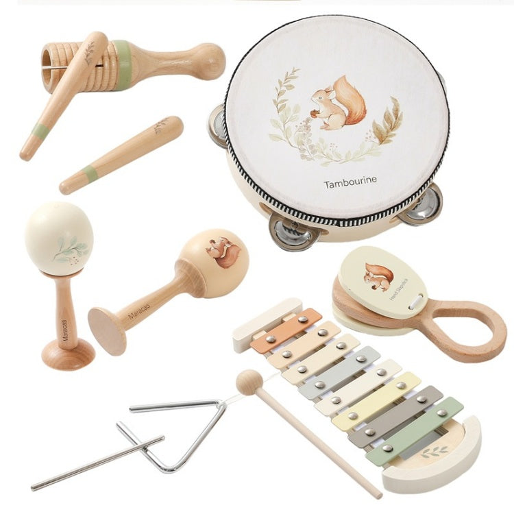 Collection of wooden musical instruments including a tambourine, maracas, xylophone, and triangle on a white background.