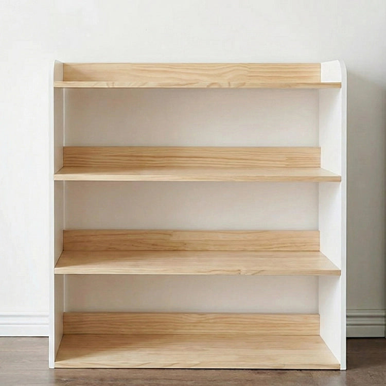 Wooden bookshelf with four shelves against a white wall.