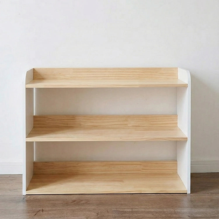 Wooden bookshelf with white frame against a plain wall