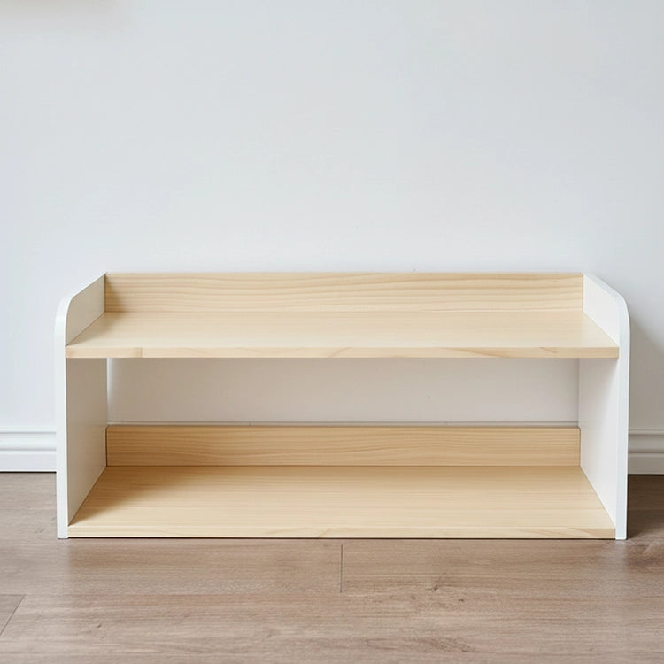 Wooden shelf with white base on a wooden floor against a white wall