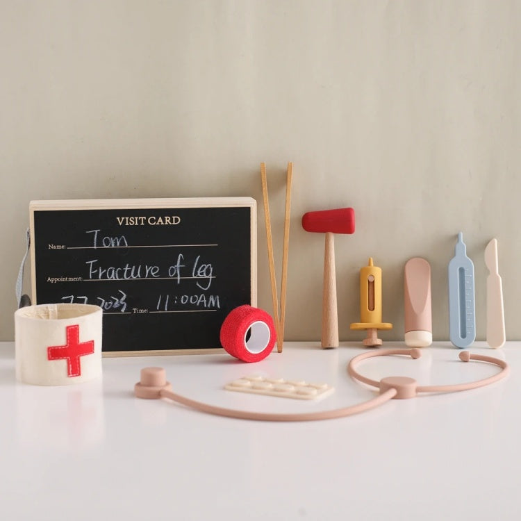 Medical toy set with a blackboard, bandages, and tools on a white surface.