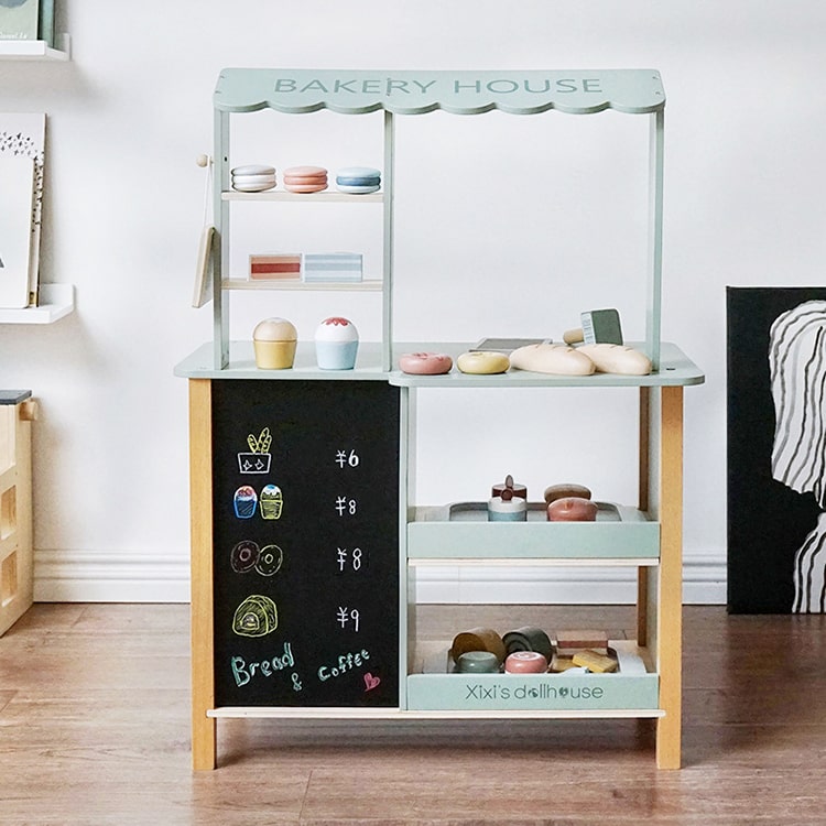 Children's play kitchen set with shelves and a chalkboard door, labeled 'Bakery House'.