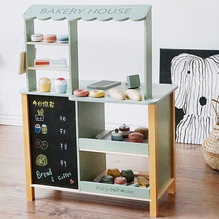 Children's play kitchen set with shelves and a chalkboard front, labeled 'Bakery House'.
