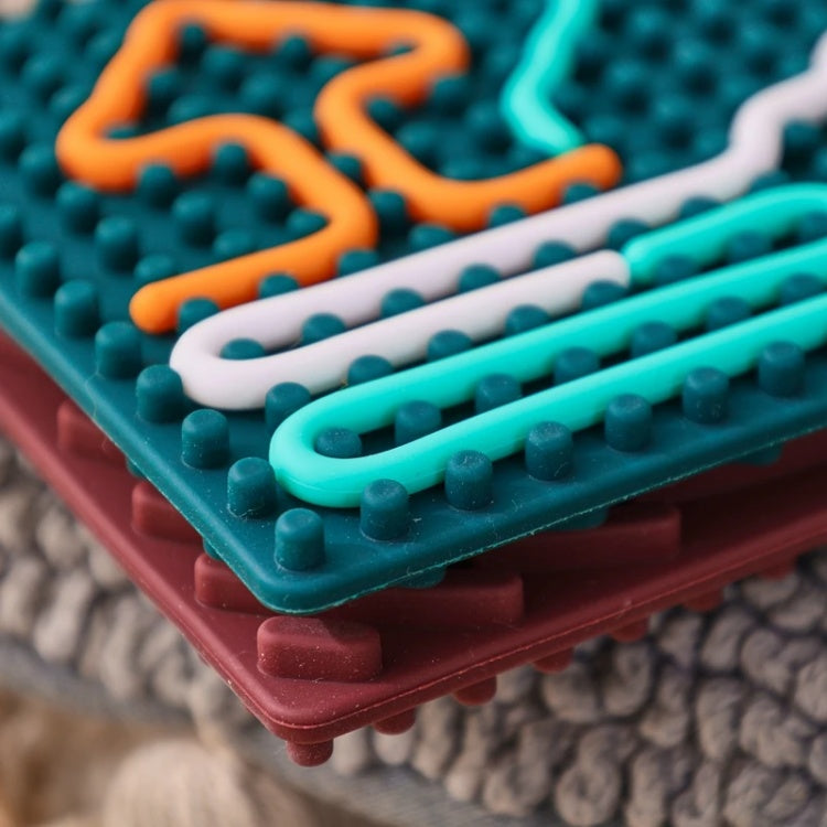 Colorful textured surface with interlocking pieces on a soft fabric background