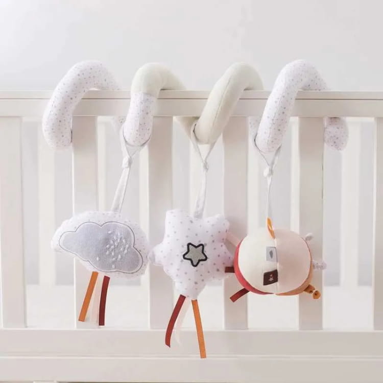 Baby mobile with cloud, star, and moon design hanging from a crib.